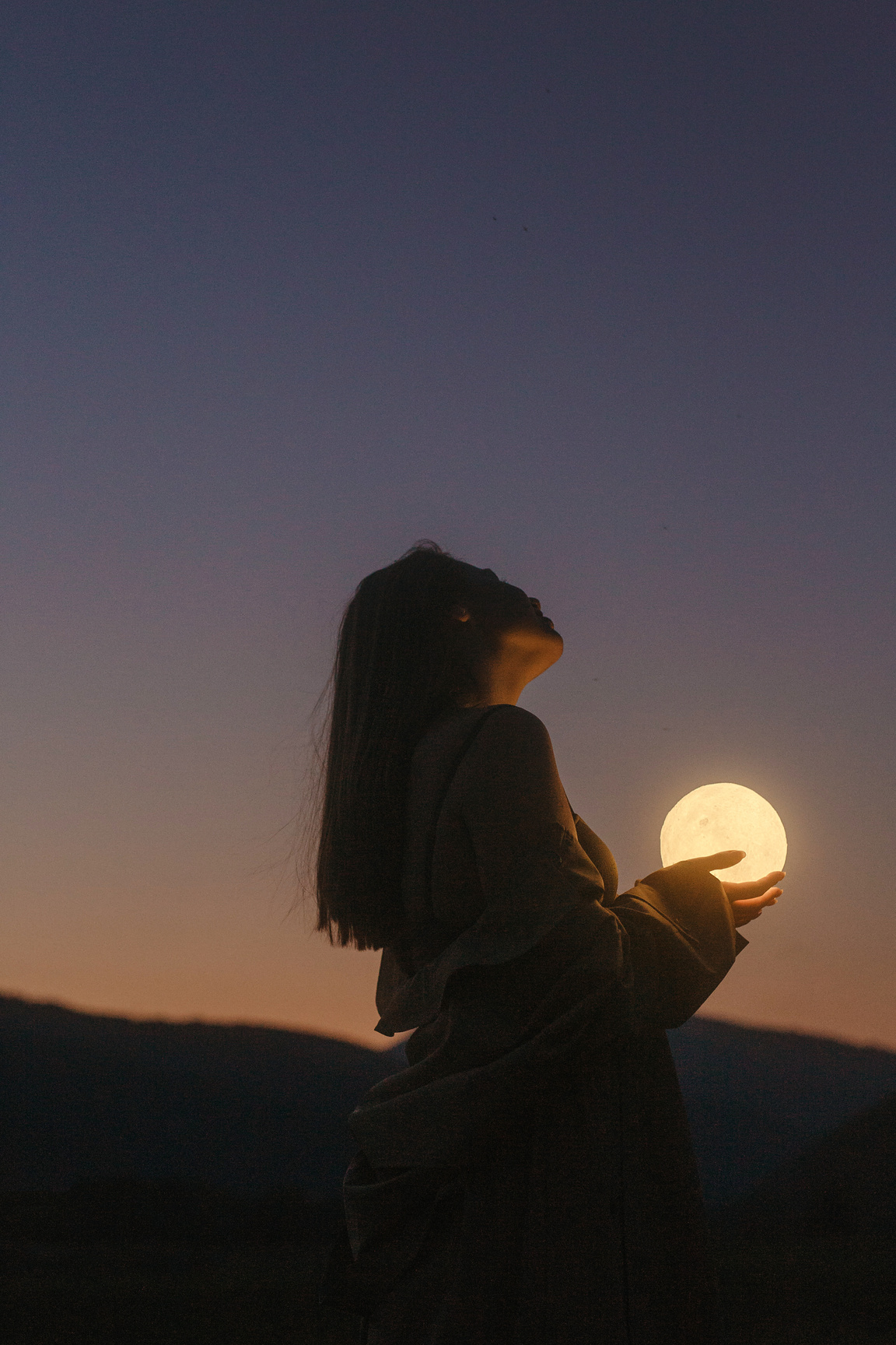 Silhouette of Woman Looking at the Moon